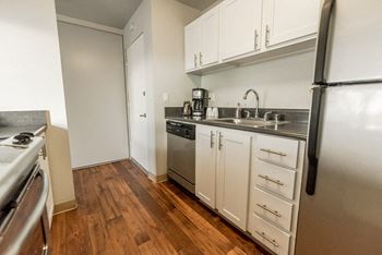 A kitchen with stainless steel appliances and white cabinets